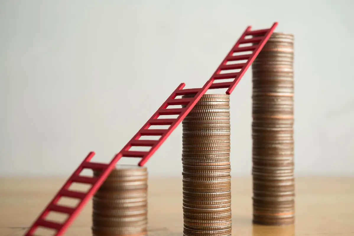 Stacked coins with ladders reaching eachother